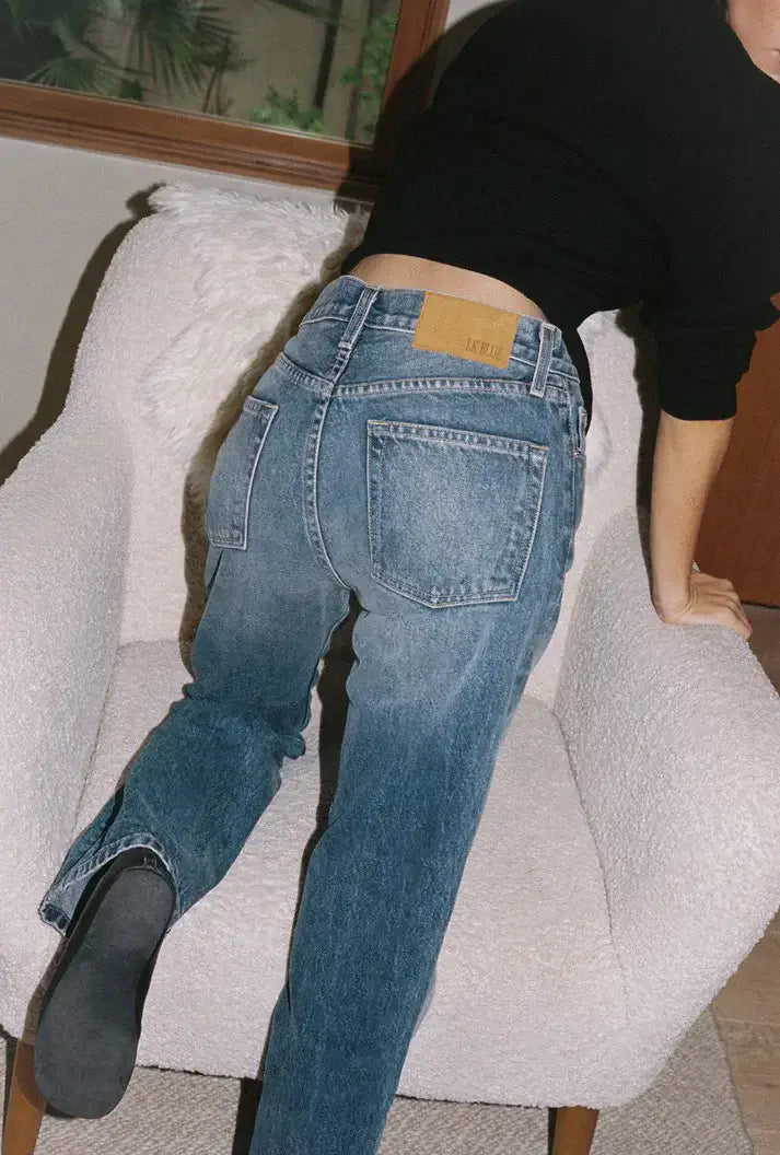 a girl beinding wearing blue jeans dispalying brand lkblue