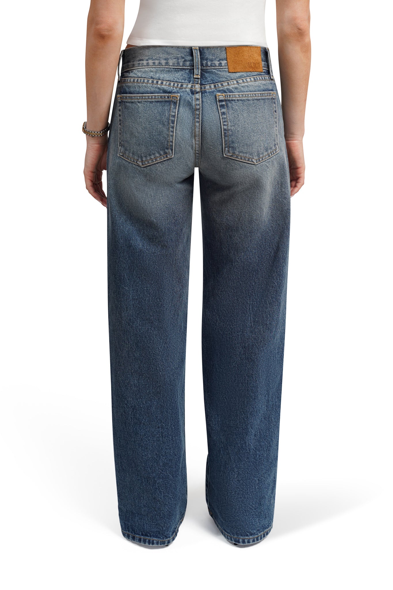bootcut jeans worn by a person on a white background