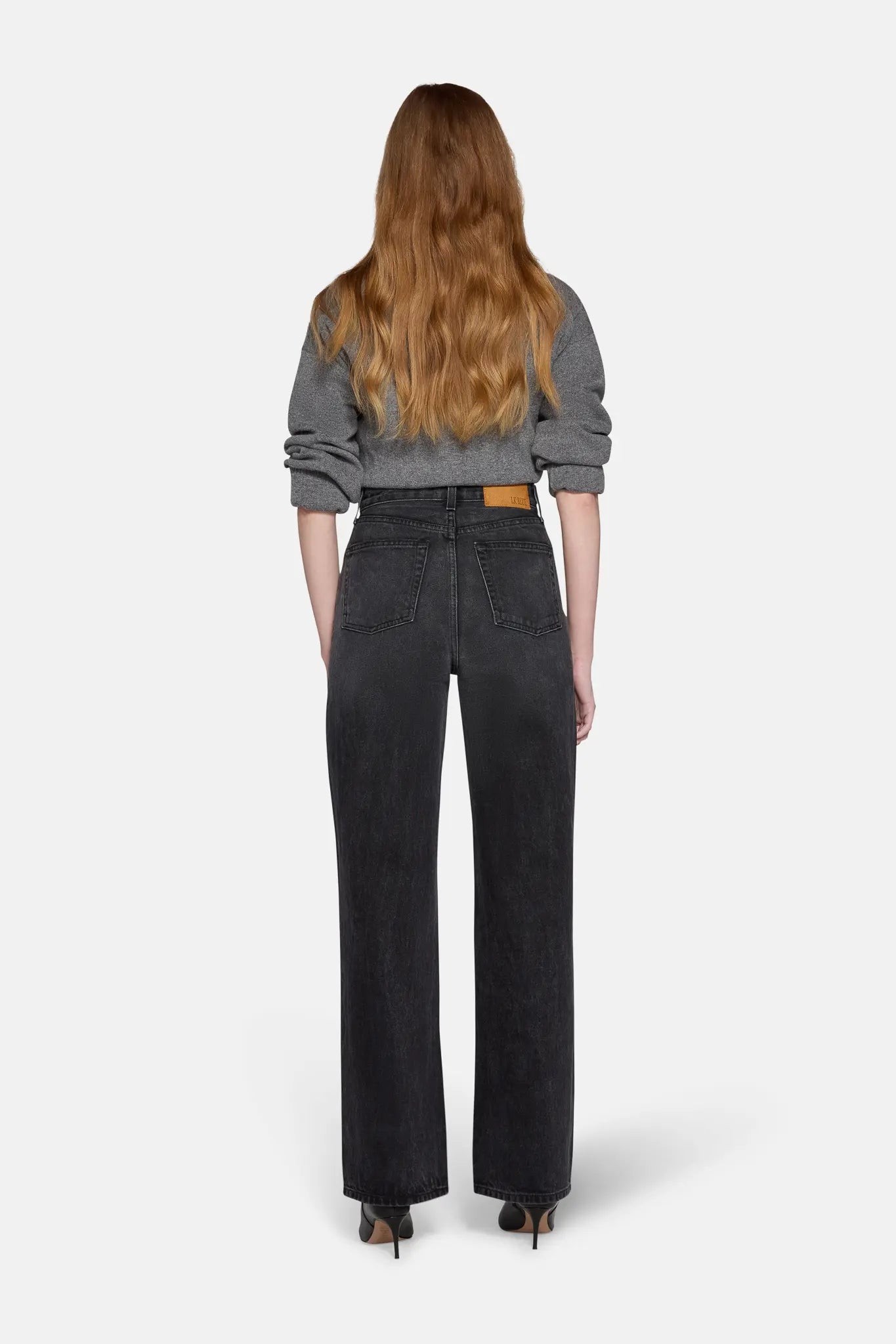 model wearing high rise straight leg jeans in charcoal 