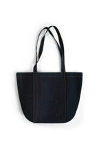 Black denim tote bag with white handles on a white background
