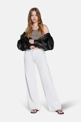 low rise baggy jean styled by a model with black jacket 