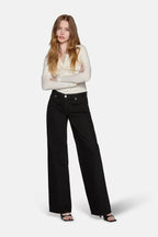 model styling black low rise baggy jeans for women
