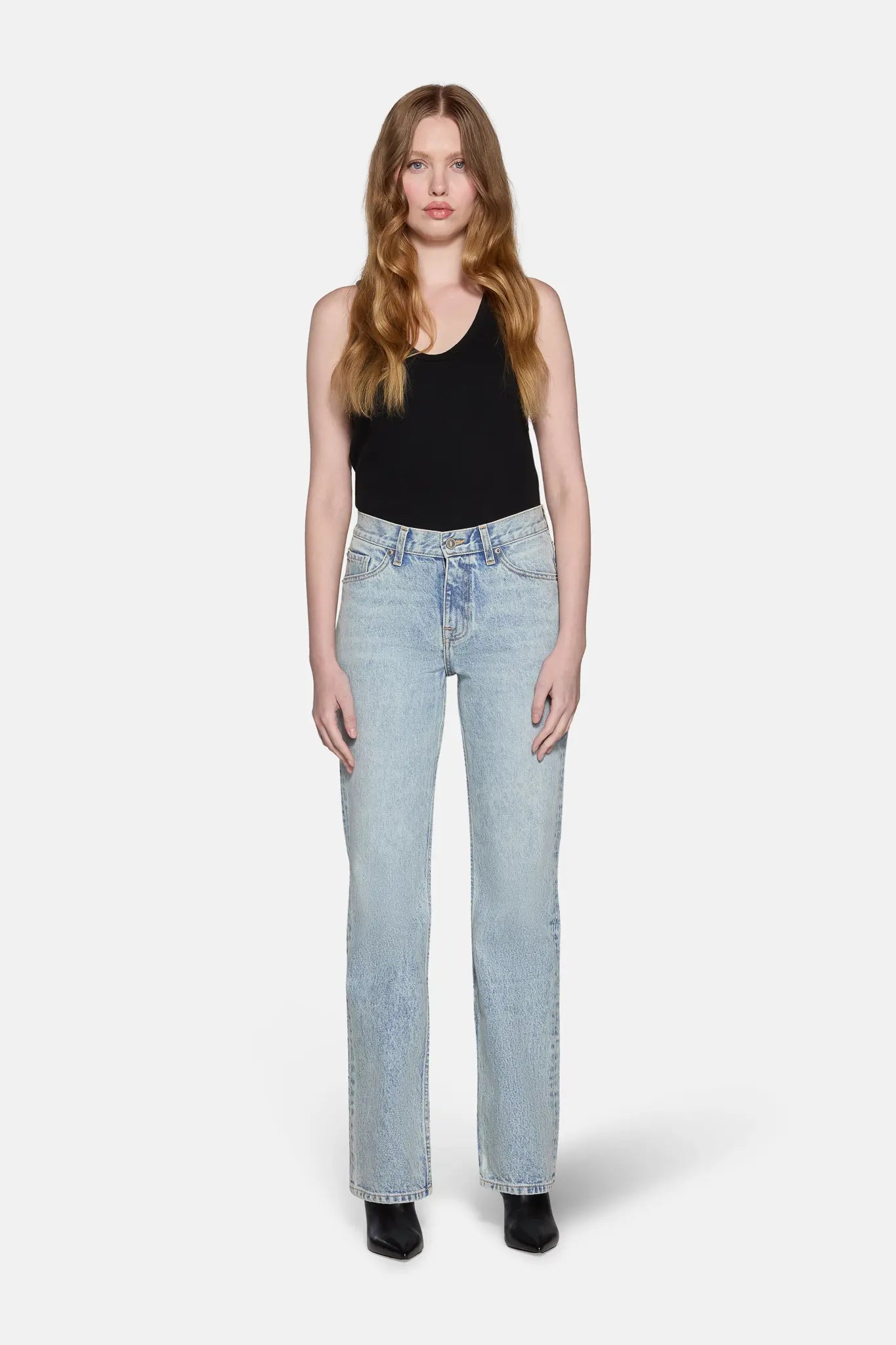 women wearing black top and light blue bootcut jeans for women 