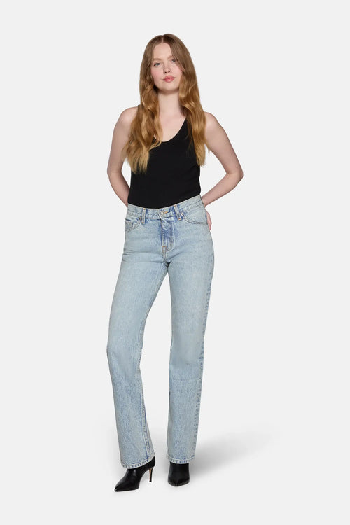 a model styled in bootcut jeans in blue color 