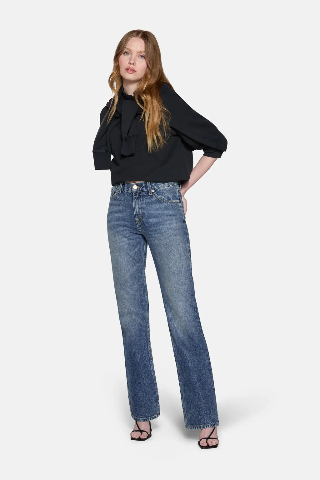 women styled in black top and boot cut jeans for women