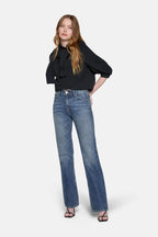 women styled in black top and boot cut jeans for women
