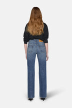 women styled in black top and boot cut jeans for women in blue 