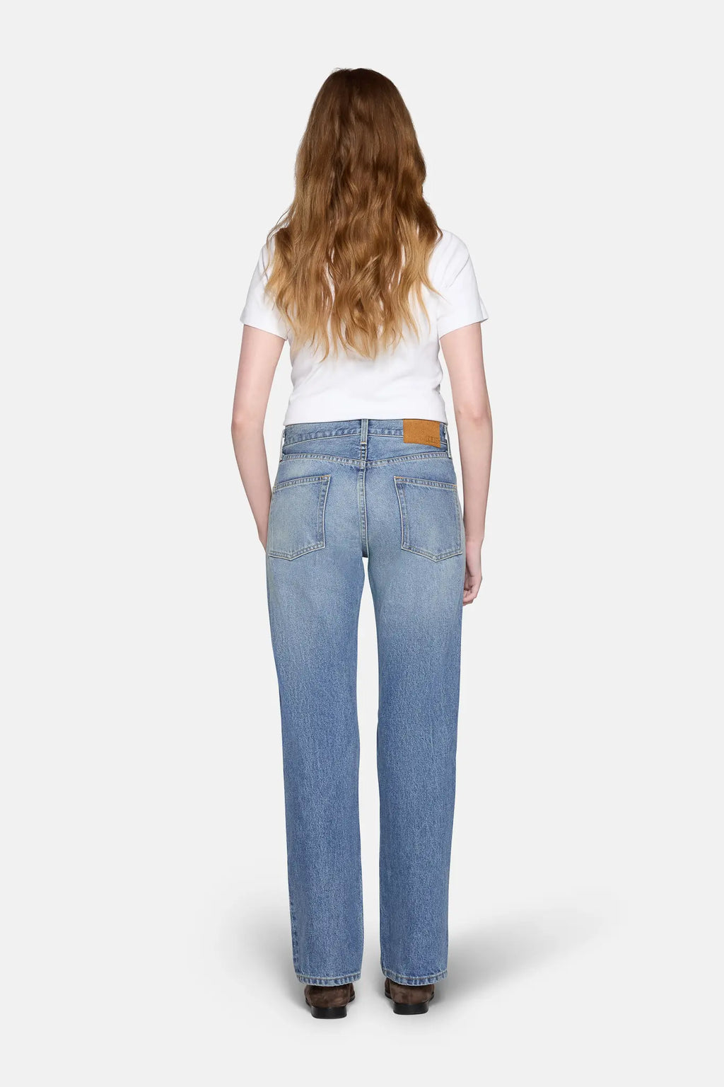 light wash straight leg jeans, back cover with blonde hair 