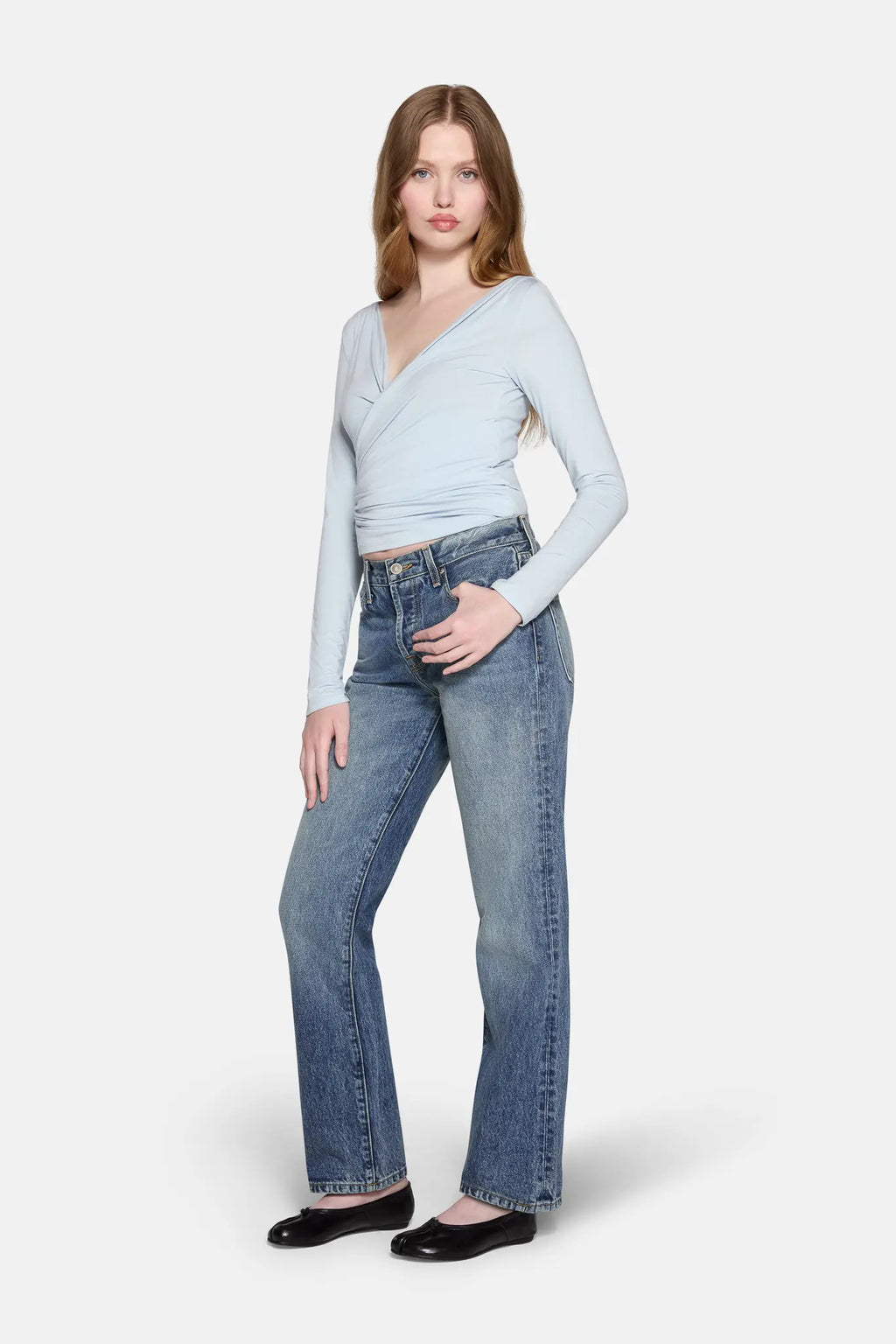 a model standing wearing  women low rise straight  leg jeans by LKBLUE 