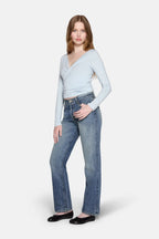a model standing wearing  women low rise straight  leg jeans by LKBLUE 