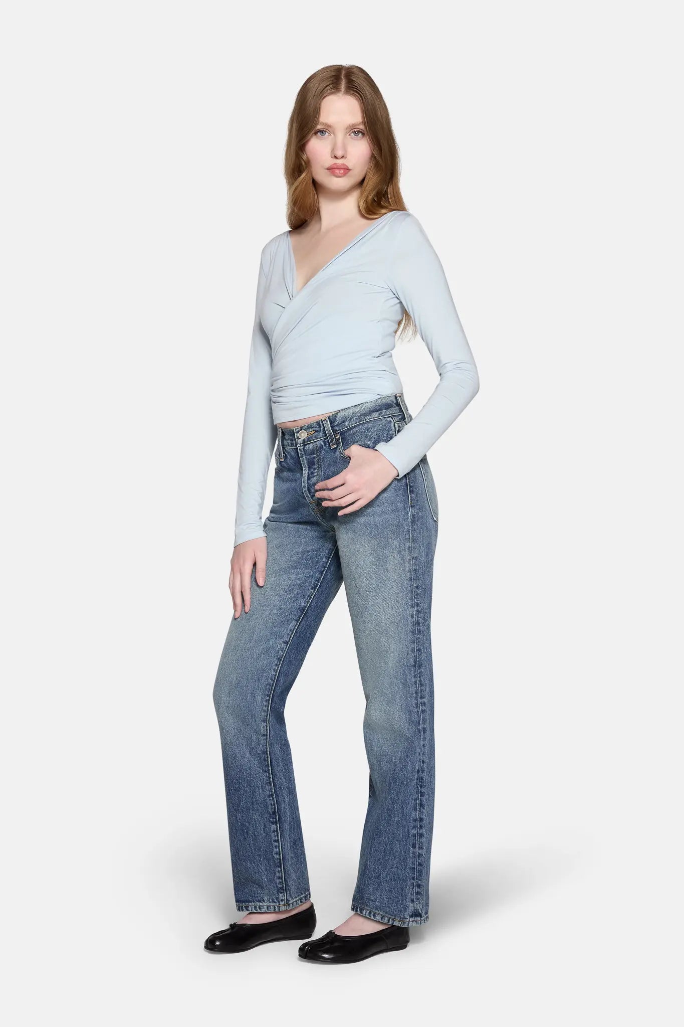 a model standing wearing  women low rise straight  leg jeans by LKBLUE 