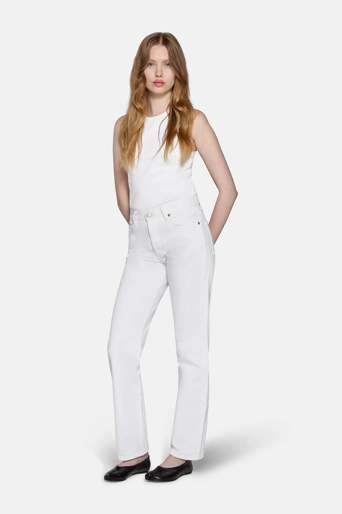 a model styled in LKBlue straight leg jeans in white 