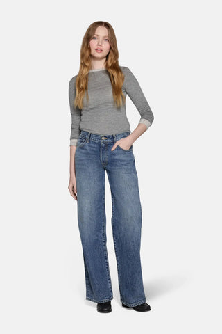 low rise baggy jeans in blue worn  by a women 