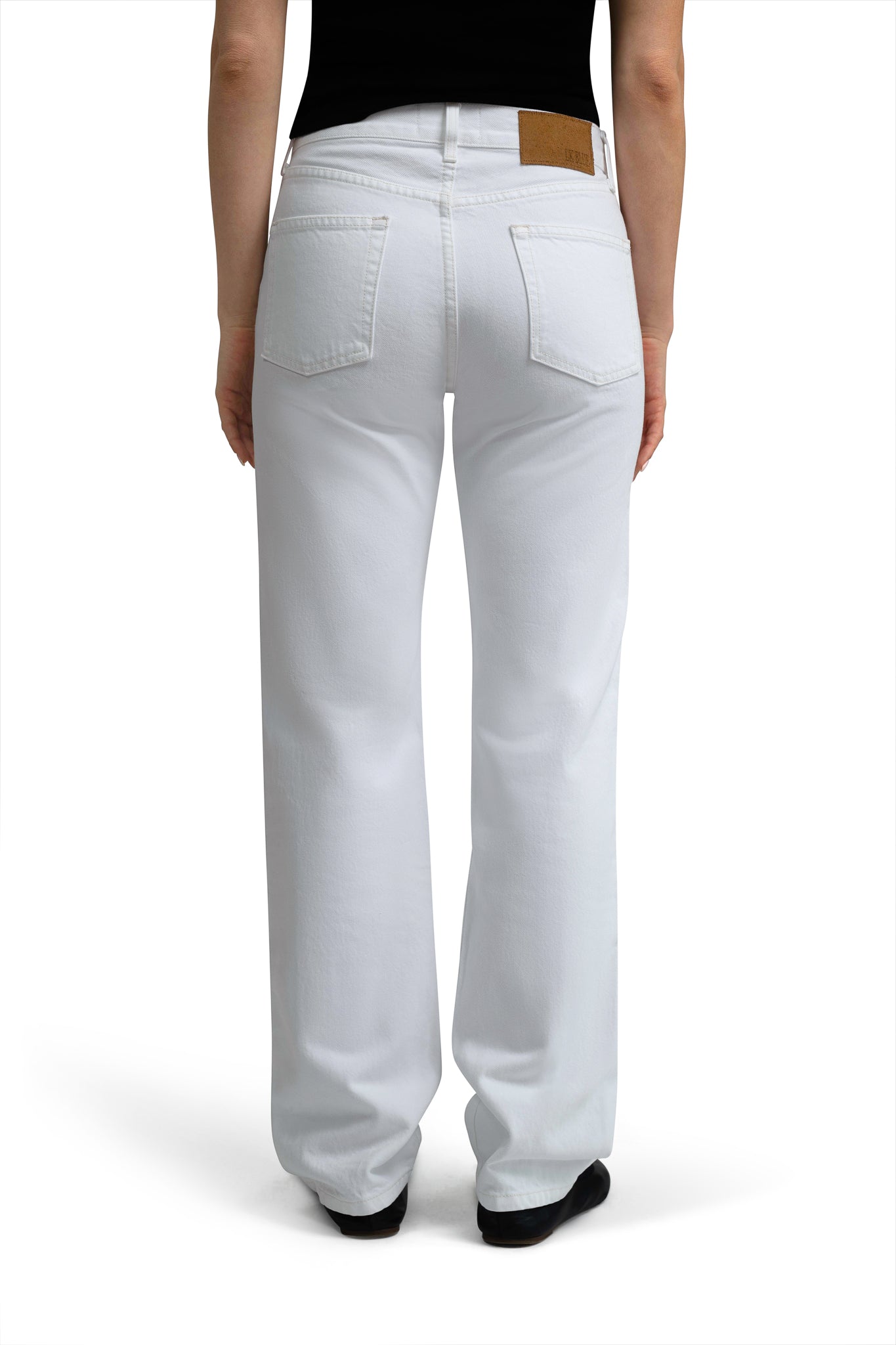 LA Denim White jeans worn by a person on a white background