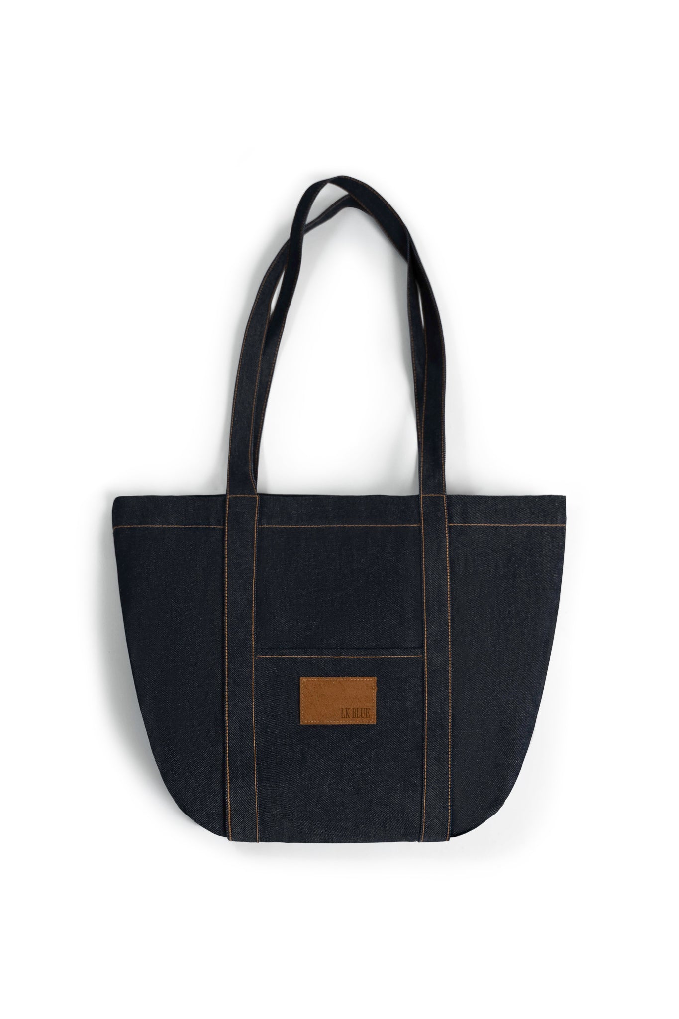 Black denim tote bag with a brown leather patch on a white background