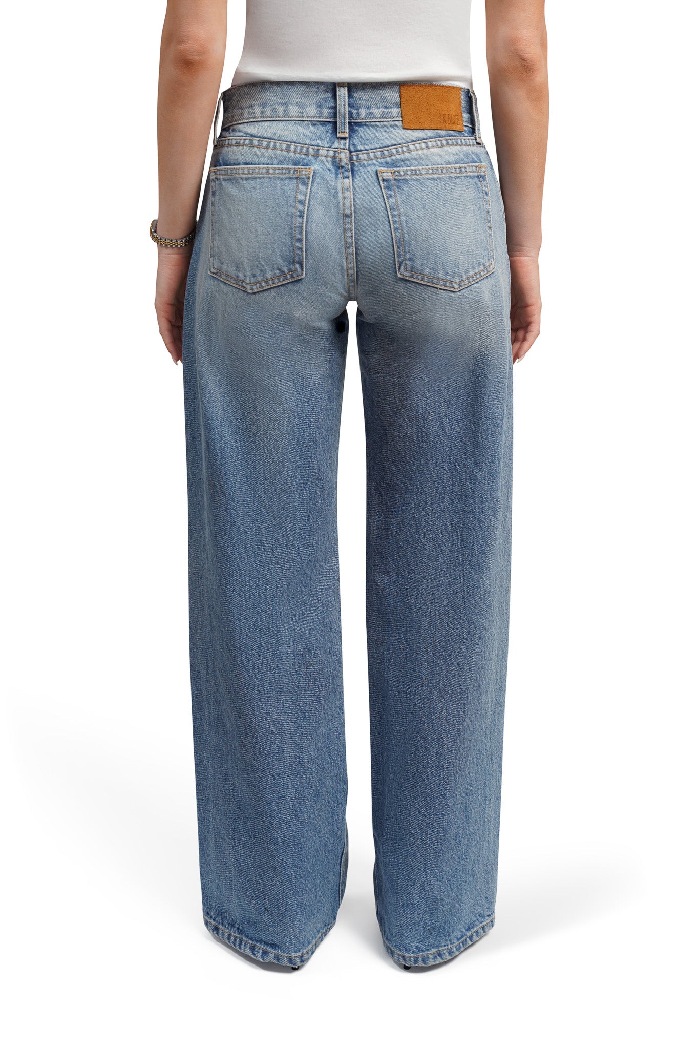 women bootcut Blue jeans worn by a person on a white background